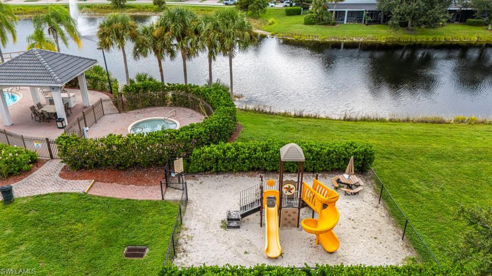 15326 Summit Pl Circle Naples, FL 34119 - Photo 20 of 21 a view of swimming pool with a table and chairs