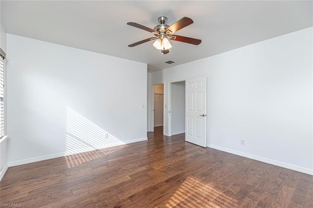 15326 Summit Pl Circle Naples, FL 34119 - Photo 8 of 21 a view of an empty room with wooden floor