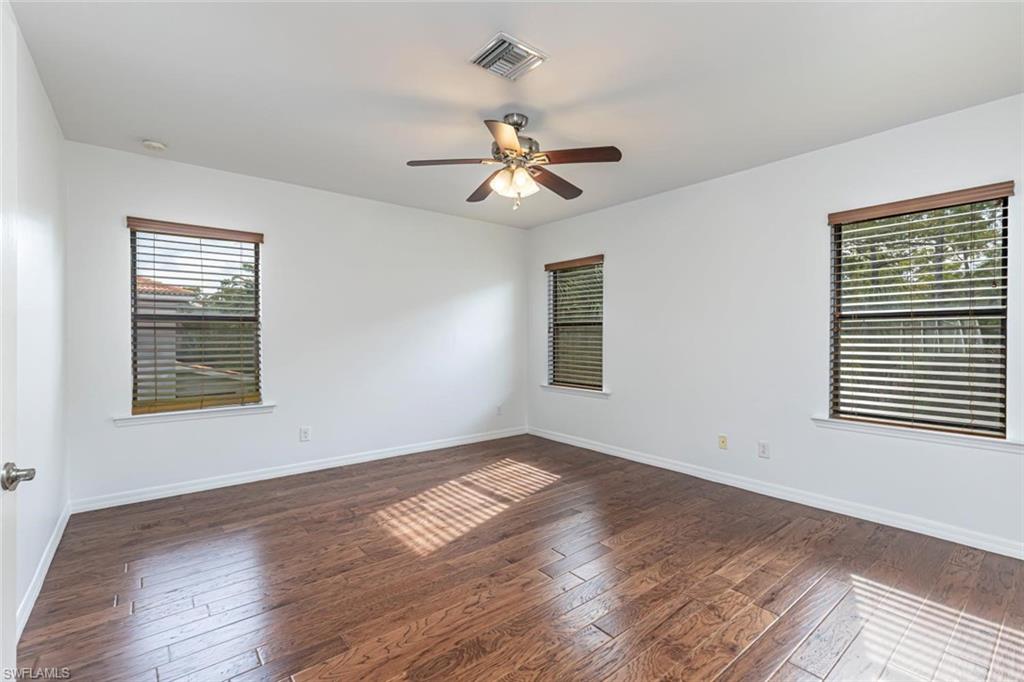 15326 Summit Pl Circle Naples, FL 34119 - Photo 9 of 21 a view of empty room with wooden floor and fan