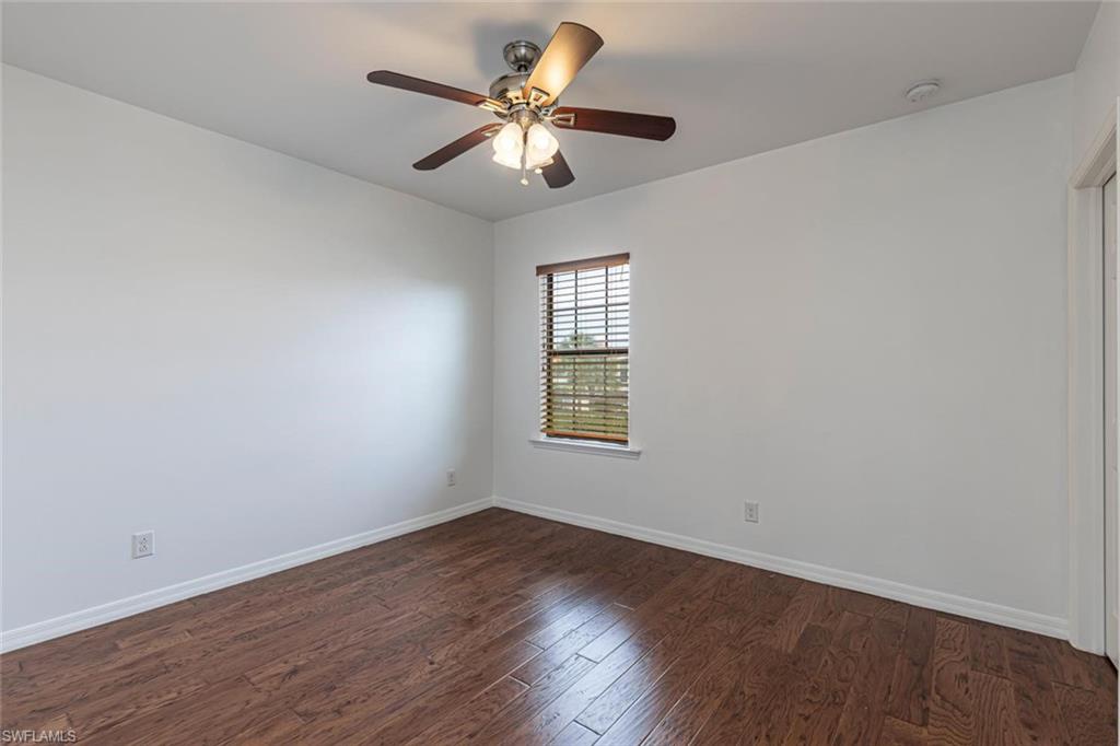 15326 Summit Pl Circle Naples, FL 34119 - Photo 10 of 21 wooden floor in an empty room with a window