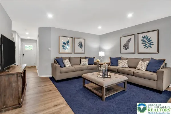 a living room with furniture and a flat screen tv