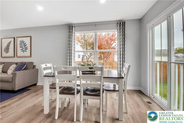 a view of a dining room with furniture and wooden floor
