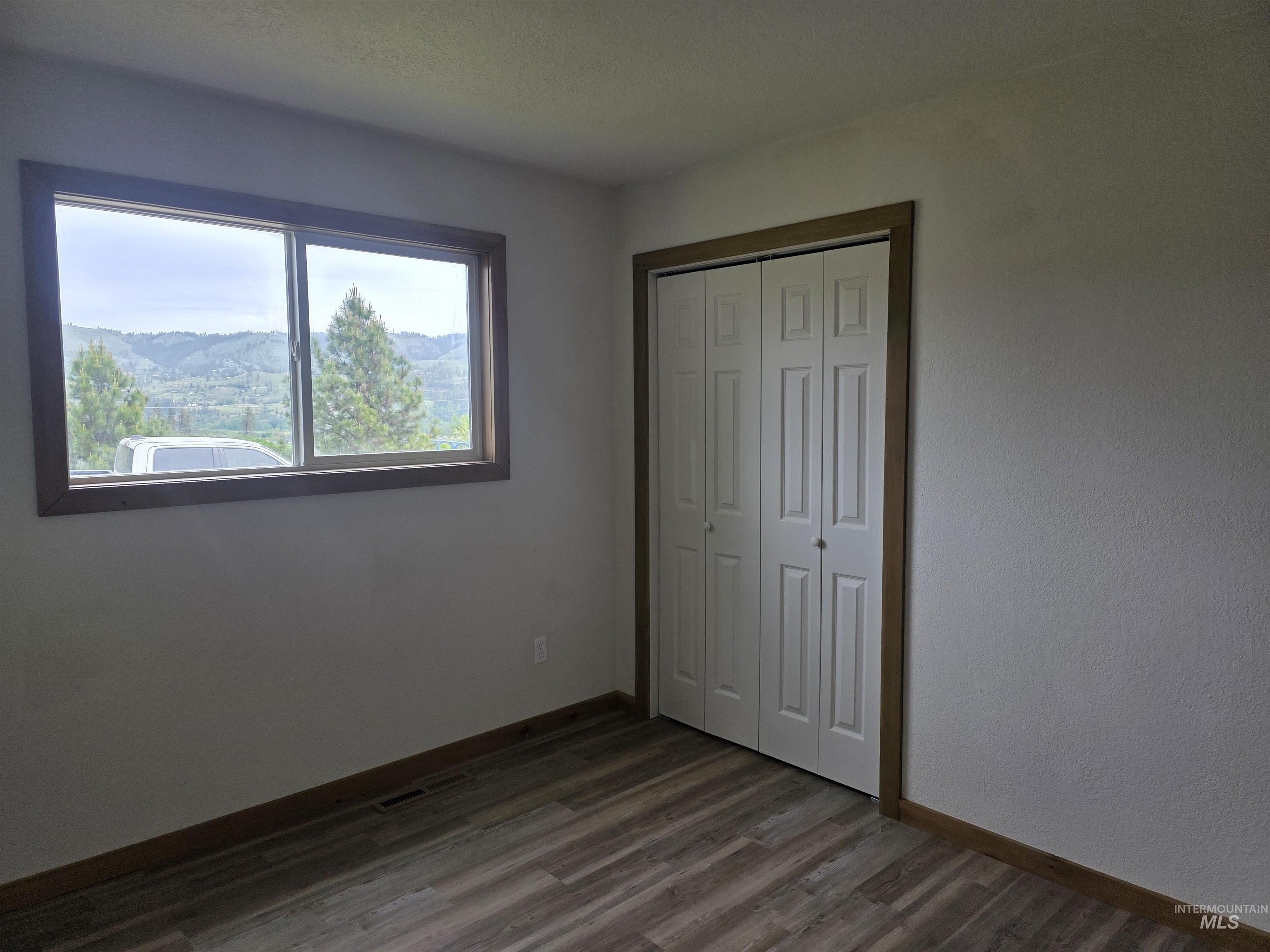 310 Fir Road Kamiah, ID 83536 - Photo 26 of 32 Bright room with a large window featuring mountain and tree scenery