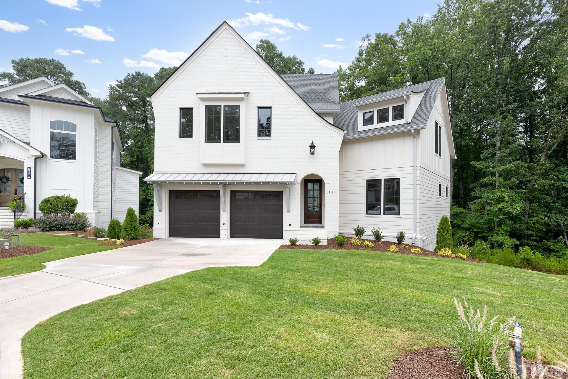 6316 Stephens Rdg Court Raleigh, NC 27615 - Photo 1 of 53 a front view of a house with a yard and garage