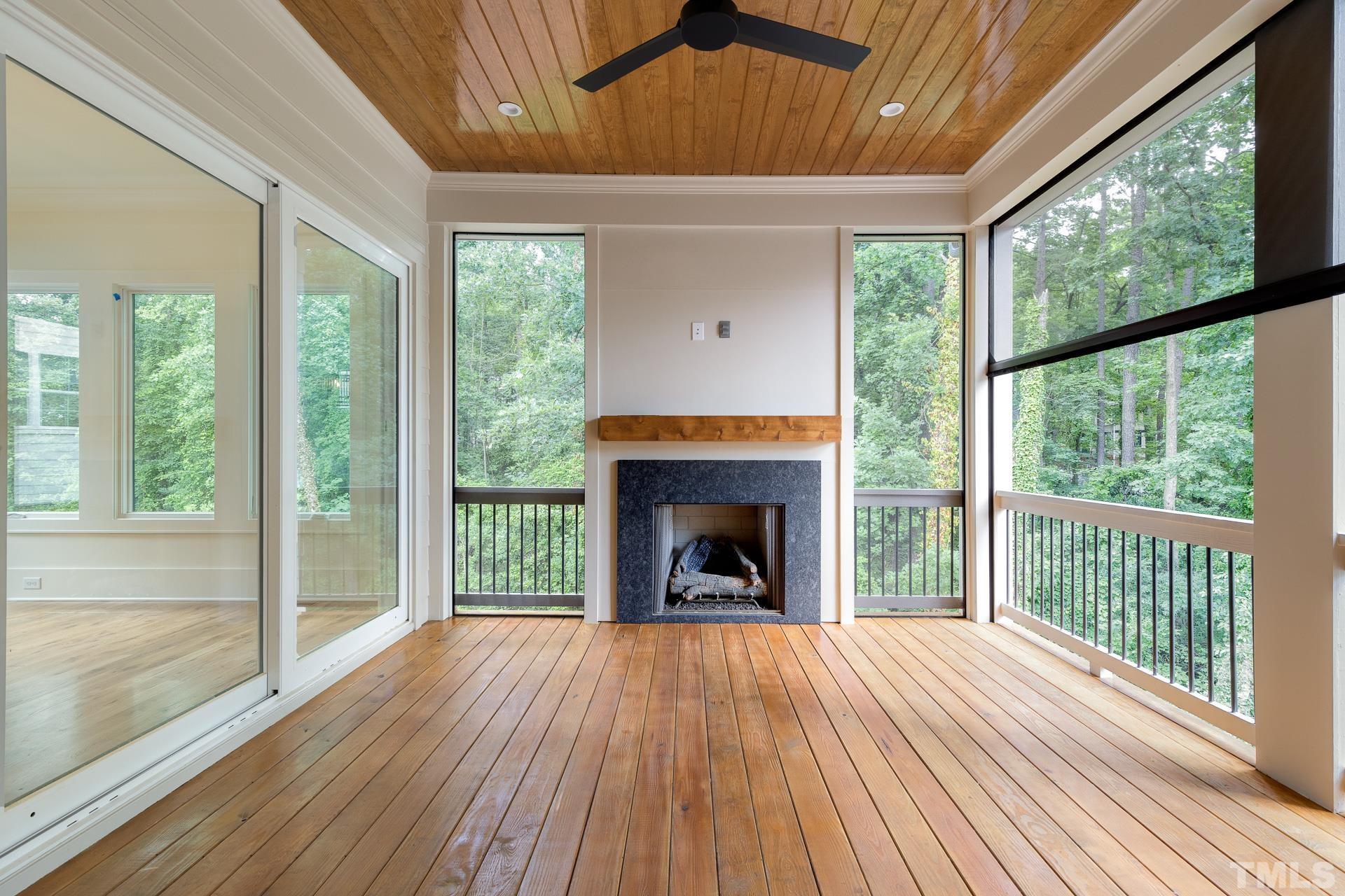 6316 Stephens Rdg Court Raleigh, NC 27615 - Photo 24 of 53 a view of an empty room with wooden floor fireplace and a window