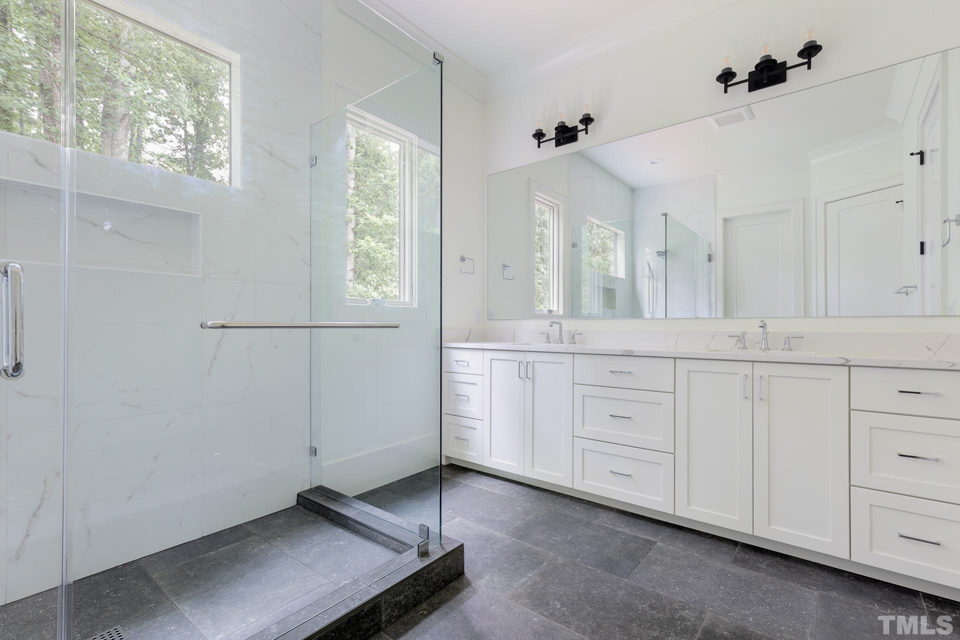 6316 Stephens Rdg Court Raleigh, NC 27615 - Photo 28 of 53 a spacious bathroom with a granite countertop sink mirror and a