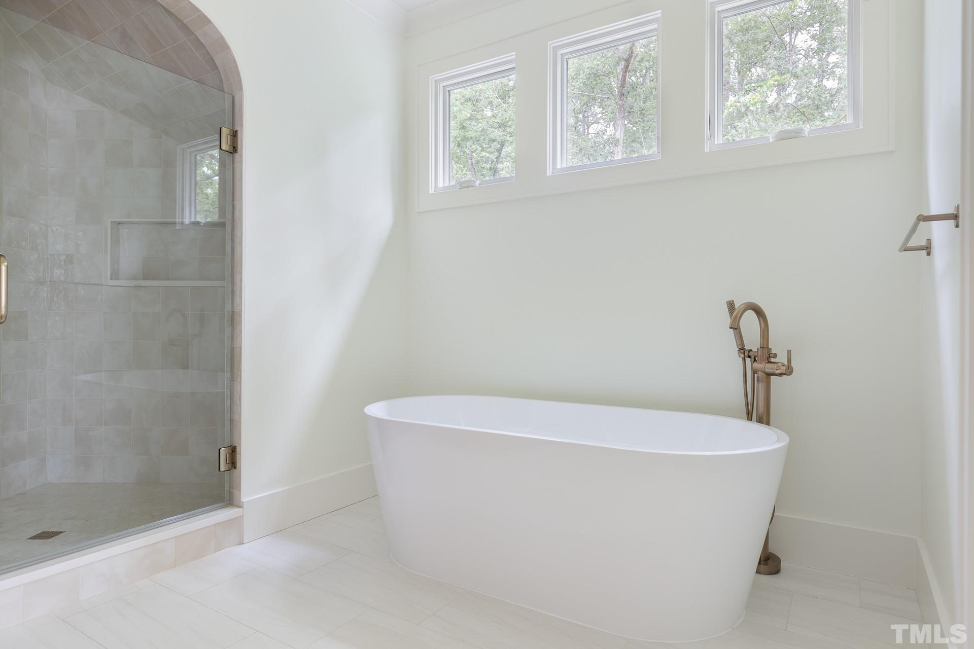 6316 Stephens Rdg Court Raleigh, NC 27615 - Photo 36 of 53 a white bath tub sitting in a bathroom