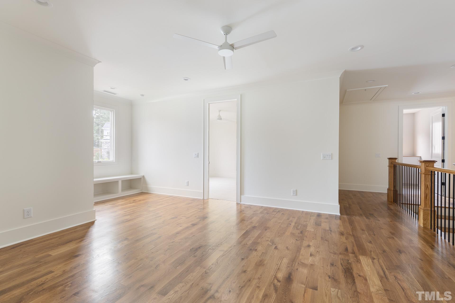 6316 Stephens Rdg Court Raleigh, NC 27615 - Photo 38 of 53 an empty room with wooden floor and a ceiling fan