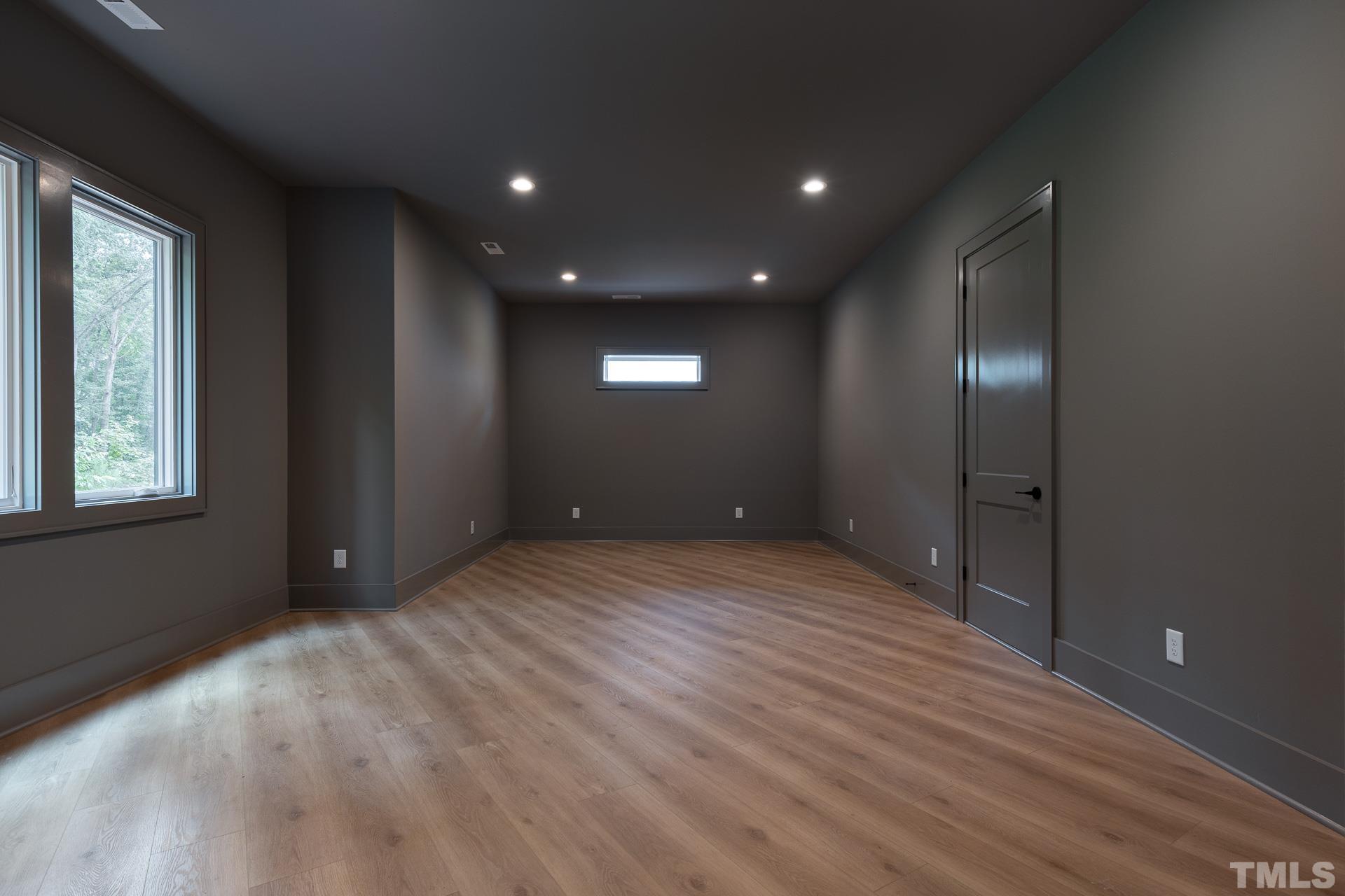 6316 Stephens Rdg Court Raleigh, NC 27615 - Photo 50 of 53 a view of an empty room with wooden floor and windows
