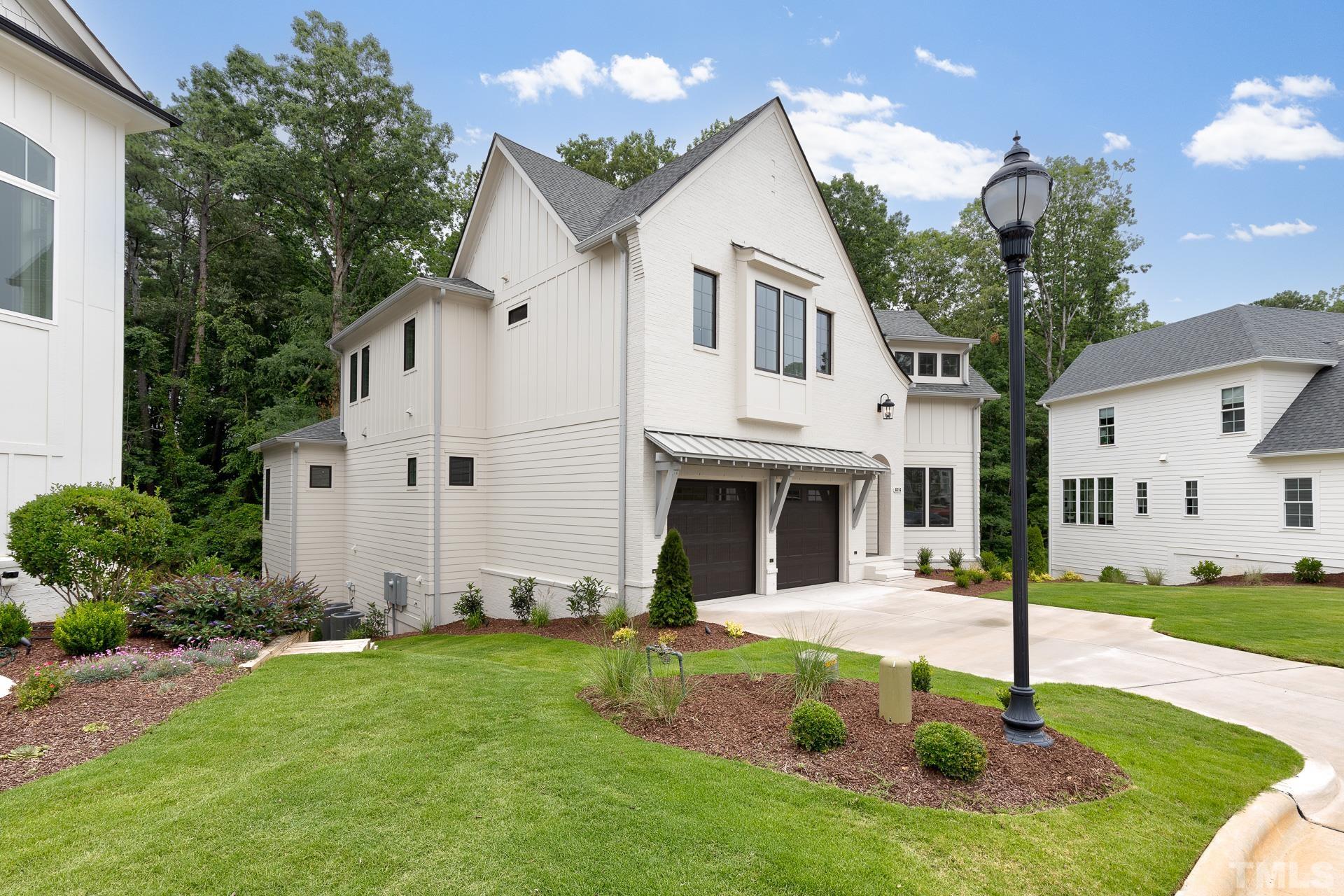 6316 Stephens Rdg Court Raleigh, NC 27615 - Photo 5 of 53 a view of a white house with a small yard and large tree