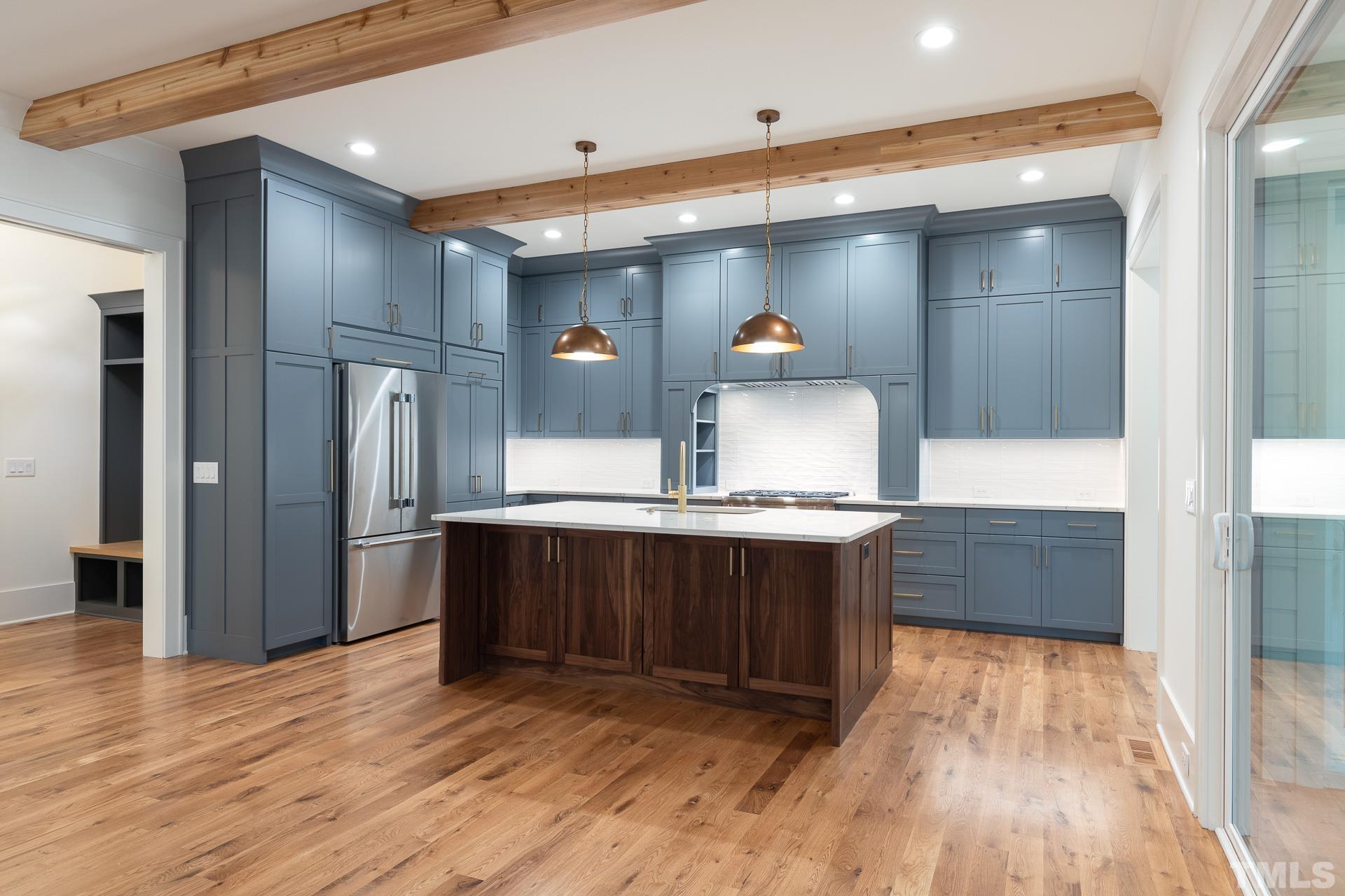 6316 Stephens Rdg Court Raleigh, NC 27615 - Photo 6 of 53 a kitchen with stainless steel appliances a refrigerator and wooden floor