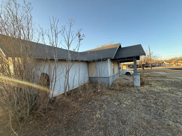 a backyard of a house with table and chairs