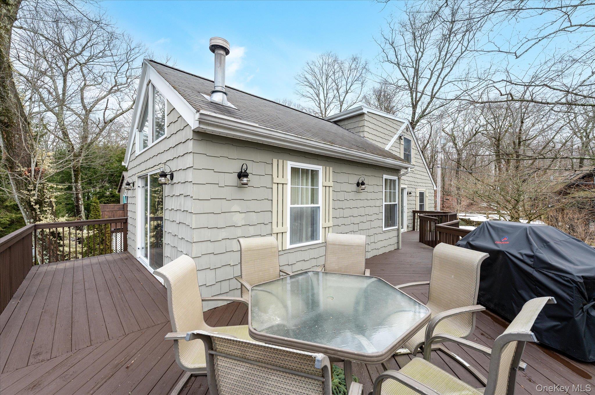 84 Hemlock Road South Salem, NY 10590 - Photo 3 of 25 a view of a patio with table and chairs with wooden floor and fence