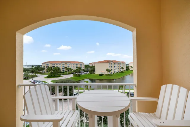 a view of a city with lots of residential buildings ocean and mountain in the back