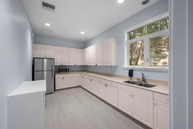 a view of a swimming pool with a patio and a yard