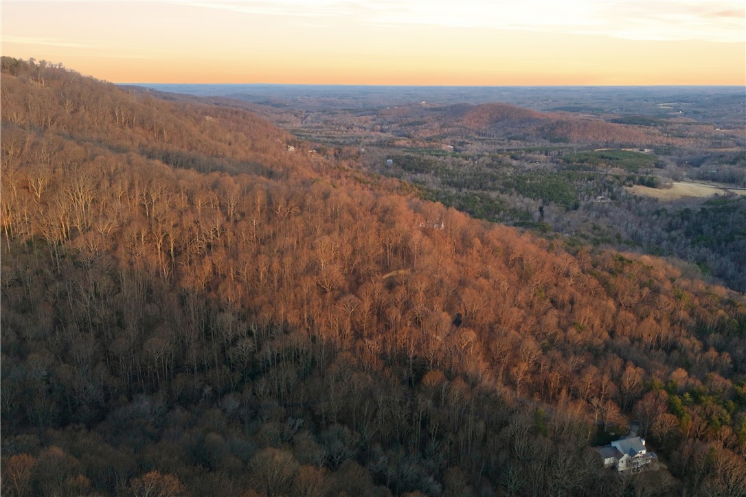 Lot 13 Hideaway Hill Way Landrum, SC 29356 - Photo 11 of 17 Perched on a serene hillside, this home offers expansive views of a majestic mountain landscape.
