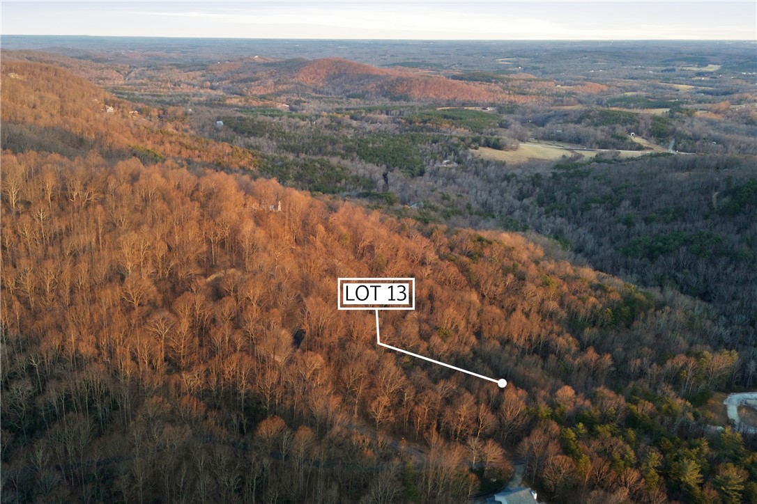 Lot 13 Hideaway Hill Way Landrum, SC 29356 - Photo 12 of 17 A sprawling lot amidst a vast, wooded landscape, offering serene views and natural beauty.
