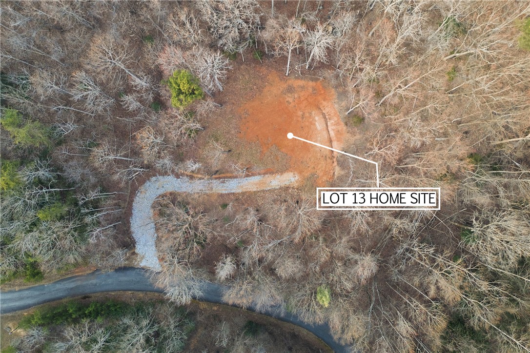 Lot 13 Hideaway Hill Way Landrum, SC 29356 - Photo 16 of 17 This aerial view showcases a ready-to-build lot nestled within a serene, wooded landscape.