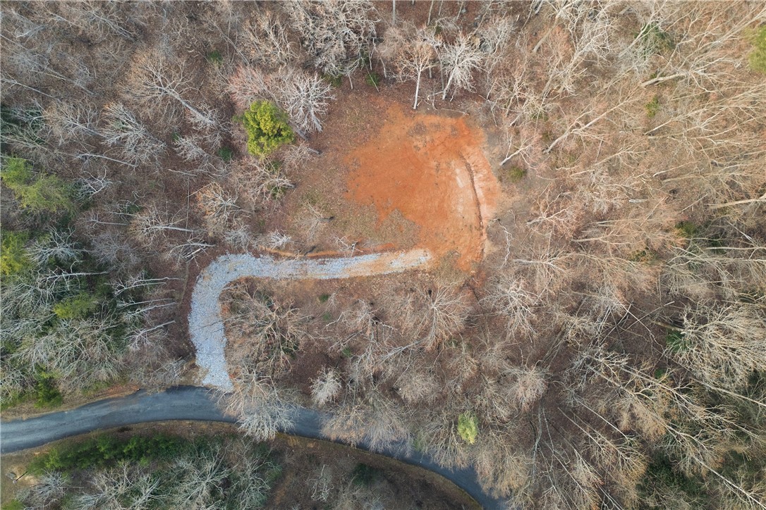 Lot 13 Hideaway Hill Way Landrum, SC 29356 - Photo 17 of 17 This aerial view showcases a cleared lot surrounded by natural wooded areas, offering a serene building site.
