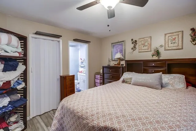 a bedroom with a large bed and a chandelier