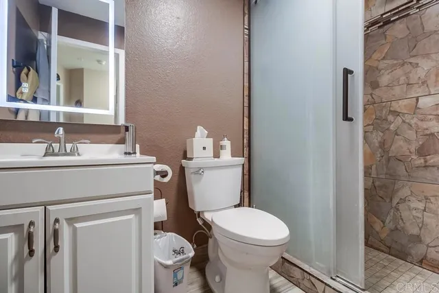 a bathroom with a sink toilet and a mirror