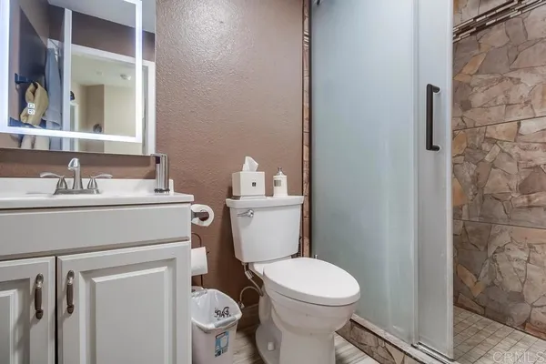 a bathroom with a sink toilet and a mirror