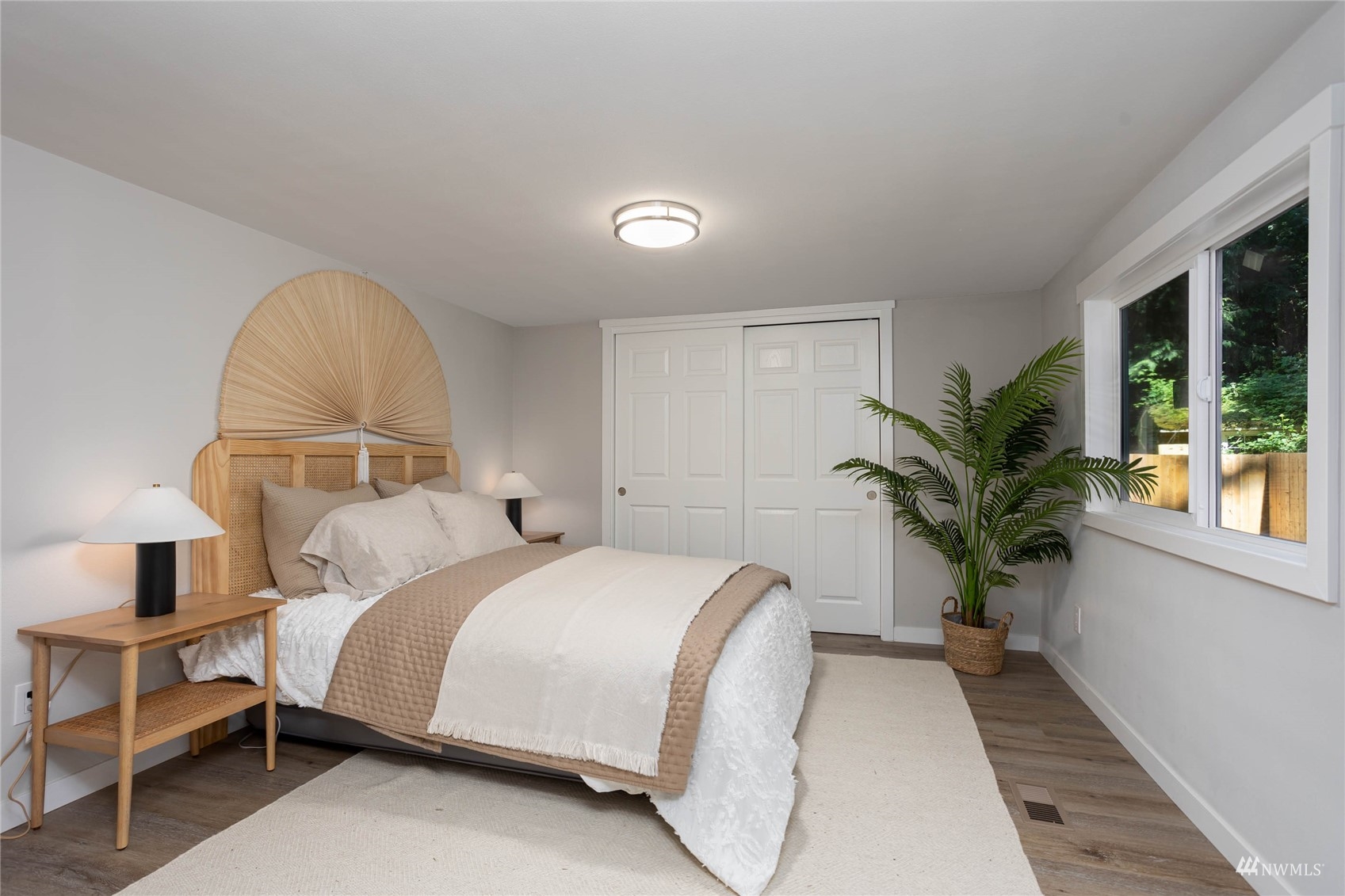 12419 Southeast 95th Way Renton, WA 98056 - Photo 11 of 30 a bedroom with a large bed and a potted plant