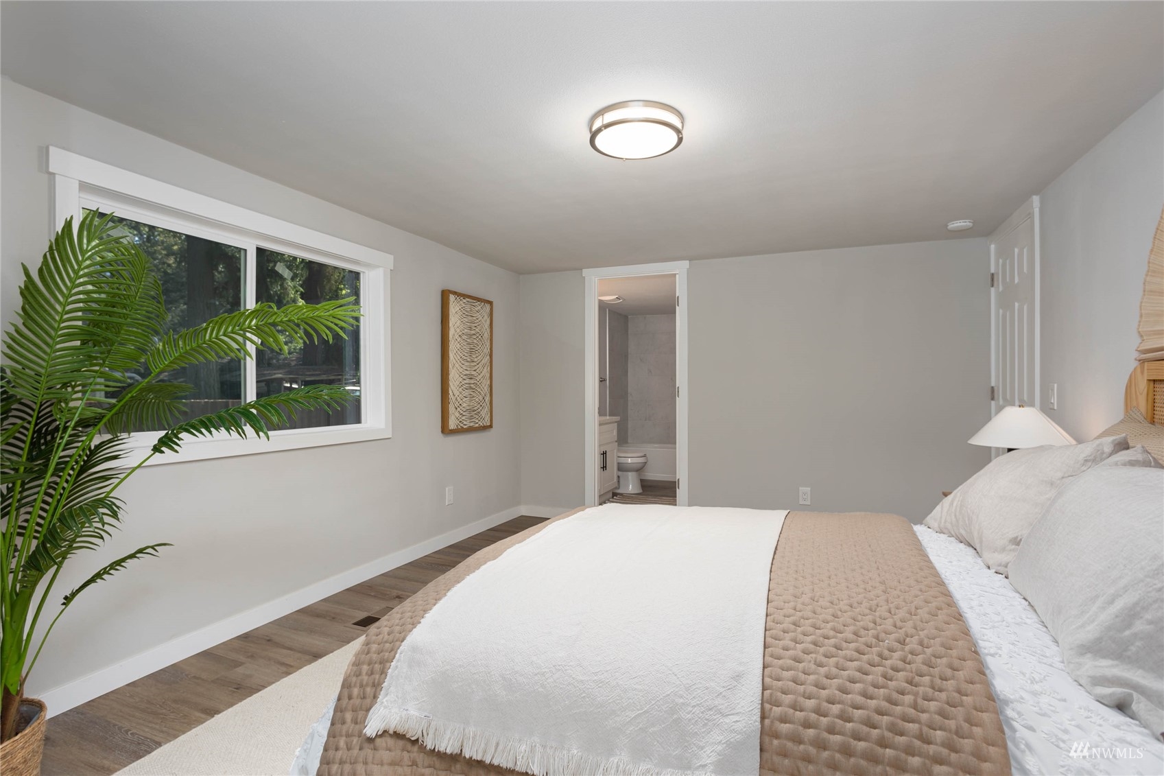 12419 Southeast 95th Way Renton, WA 98056 - Photo 12 of 30 a bedroom with a large bed and a large window