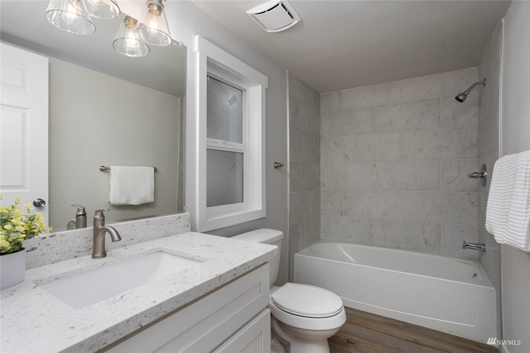 12419 Southeast 95th Way Renton, WA 98056 - Photo 13 of 30 a bathroom with a granite countertop sink a toilet and bathtub