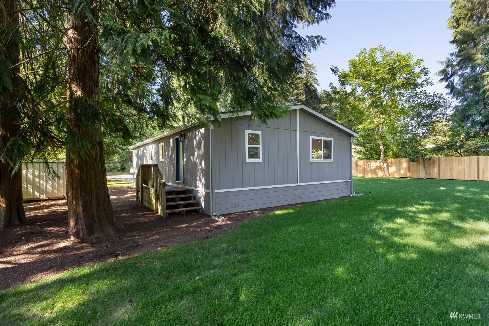 12419 Southeast 95th Way Renton, WA 98056 - Photo 23 of 30 a view of backyard with a barn and large trees