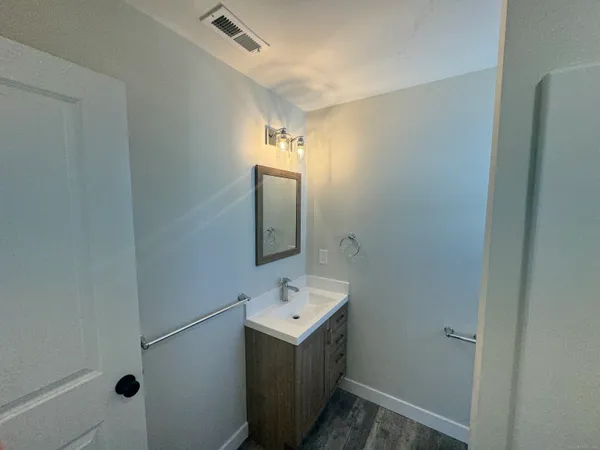 a bathroom with a sink mirror and vanity