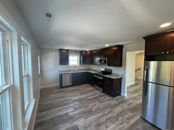 a large kitchen with a large refrigerator and a sink