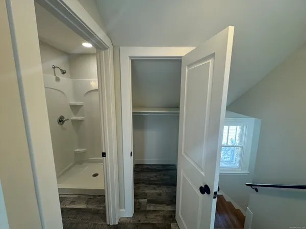 a bathroom with a shower and toilet