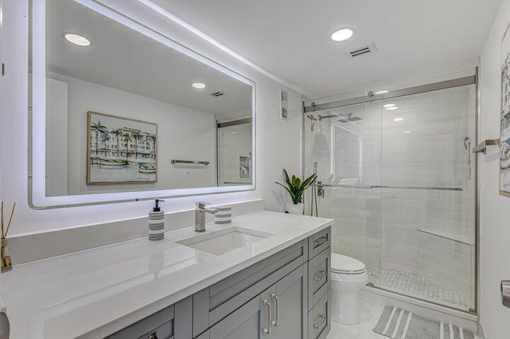 5440 North Ocean Drive, Unit 1502 Singer Island, FL 33404 - Photo 15 of 34 a bathroom with a sink a toilet and shower
