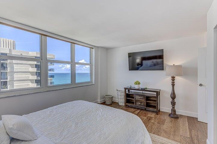 5440 North Ocean Drive, Unit 1502 Singer Island, FL 33404 - Photo 21 of 34 a bedroom with a bed and a television