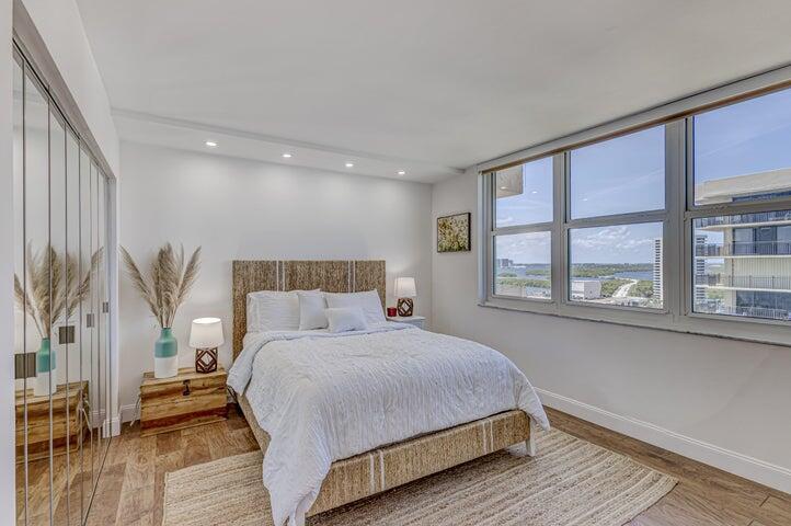 5440 North Ocean Drive, Unit 1502 Singer Island, FL 33404 - Photo 22 of 34 a bedroom with a large bed and a large window