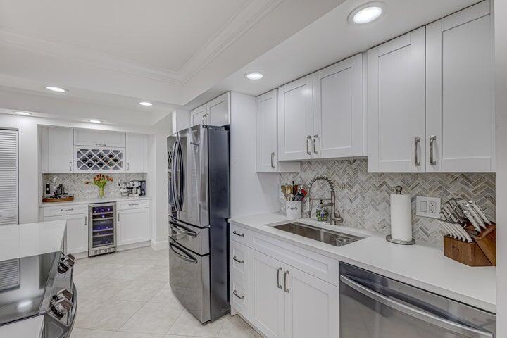 5440 North Ocean Drive, Unit 1502 Singer Island, FL 33404 - Photo 5 of 34 a kitchen with a refrigerator and a sink
