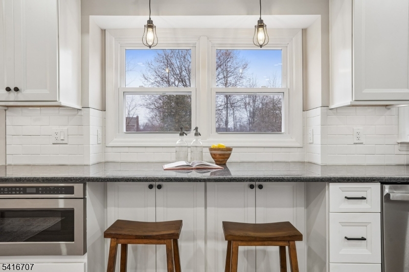 18 Juniper Way Bernards, NJ 07920 - Photo 11 of 31 a kitchen with stainless steel appliances granite countertop a sink a stove a dining table and chairs