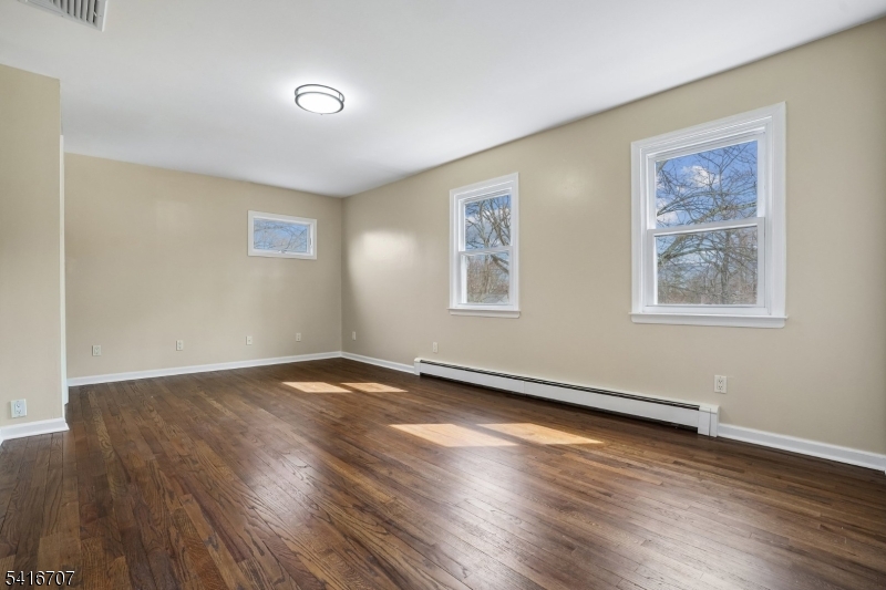18 Juniper Way Bernards, NJ 07920 - Photo 22 of 31 a view of an empty room with wooden floor and a window