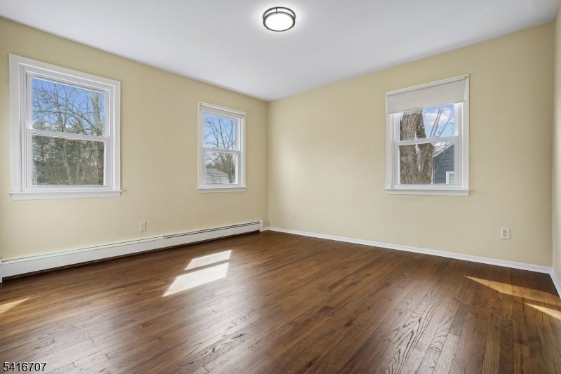 18 Juniper Way Bernards, NJ 07920 - Photo 24 of 31 a view of an empty room with wooden floor and a window