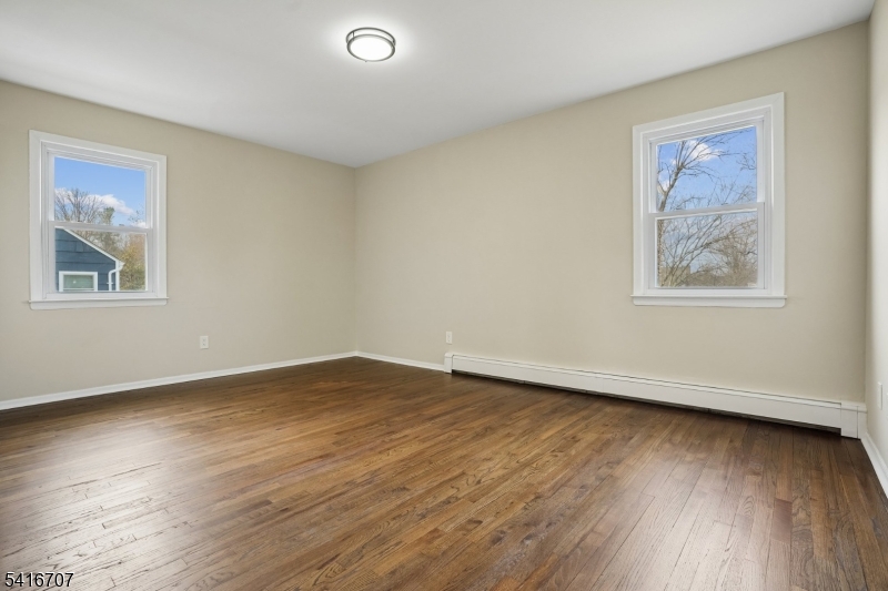 18 Juniper Way Bernards, NJ 07920 - Photo 25 of 31 a view of an empty room with wooden floor and a window