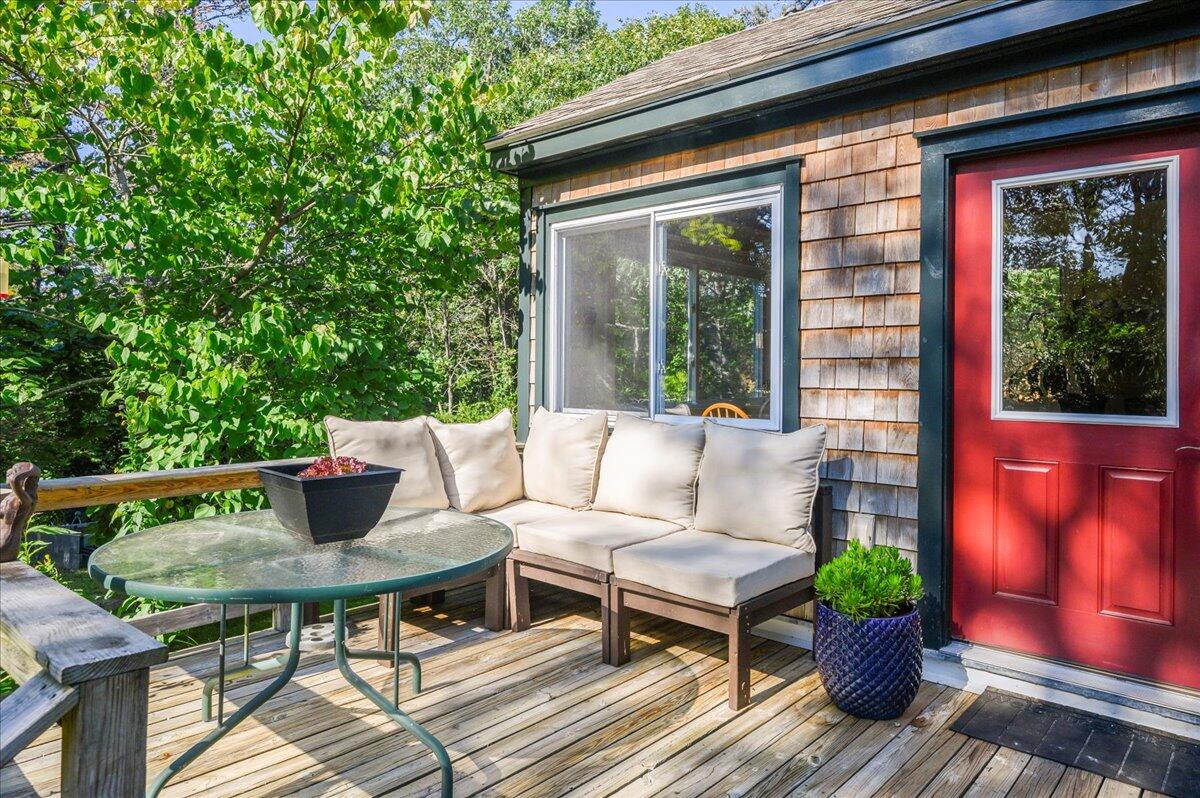 25 Cranberry Hollow Road Wellfleet, MA 02667 - Photo 1 of 18 a view of a table and chairs in the patio