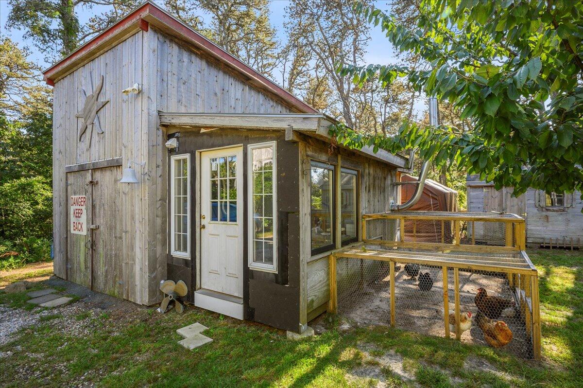 25 Cranberry Hollow Road Wellfleet, MA 02667 - Photo 14 of 18 a view of a small house with backyard