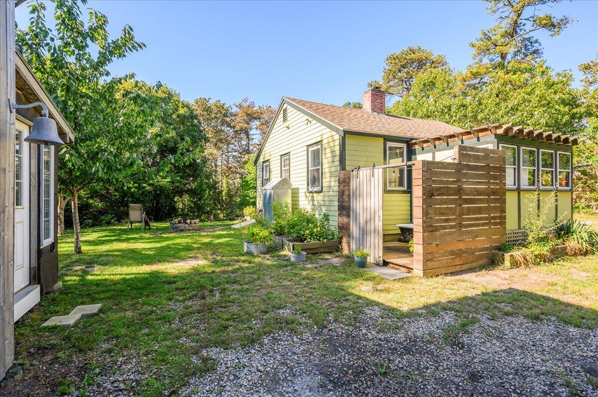 25 Cranberry Hollow Road Wellfleet, MA 02667 - Photo 16 of 18 a front view of a house with garden