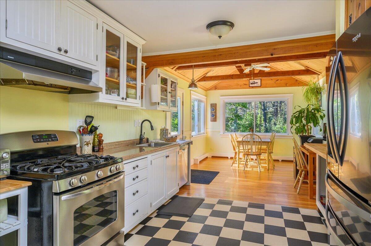 25 Cranberry Hollow Road Wellfleet, MA 02667 - Photo 4 of 18 a kitchen with stainless steel appliances a stove a sink and a refrigerator
