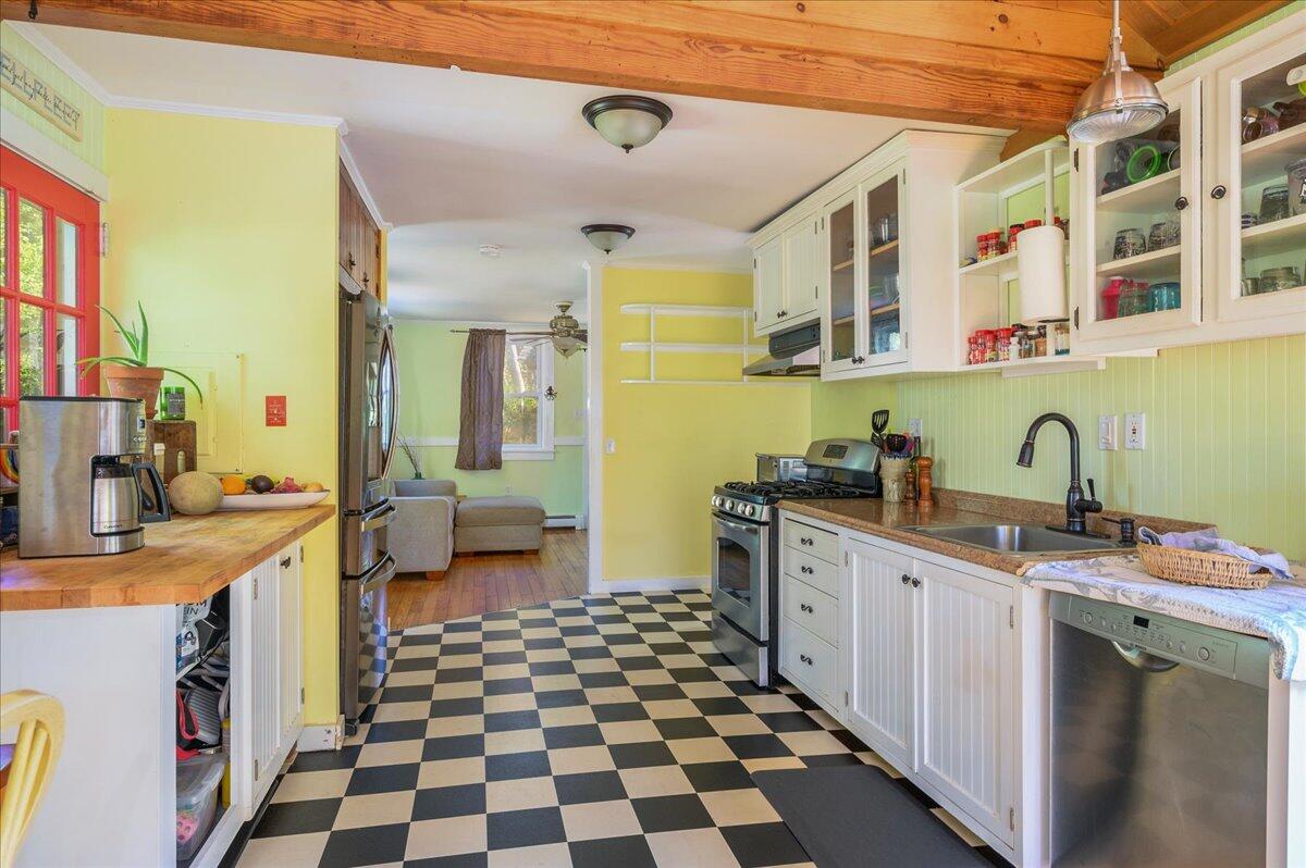 25 Cranberry Hollow Road Wellfleet, MA 02667 - Photo 5 of 18 a kitchen with a sink a stove and cabinets