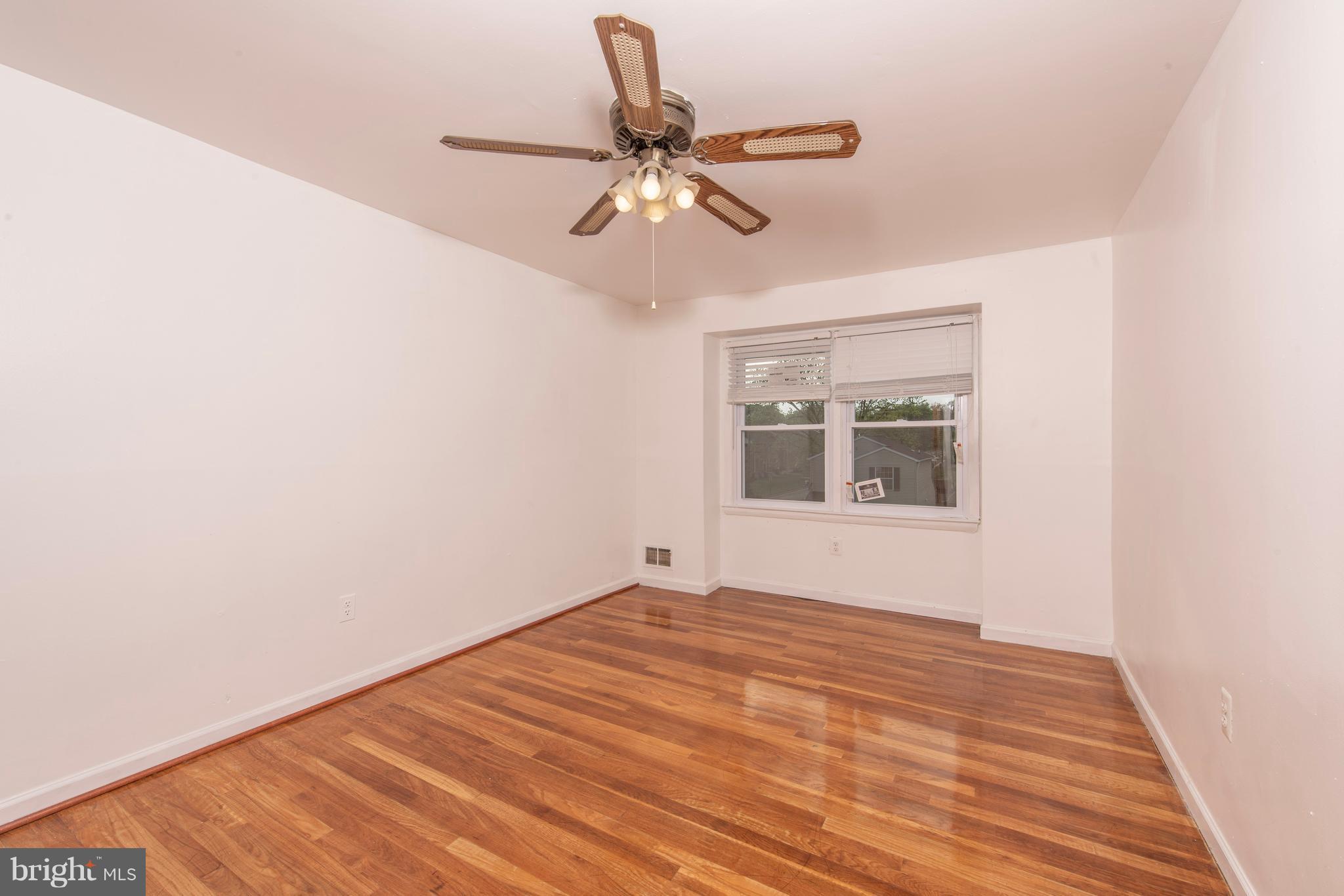 5607 Whitby Road Baltimore, MD 21206 - Photo 13 of 20 a view of empty room with wooden floor and fan