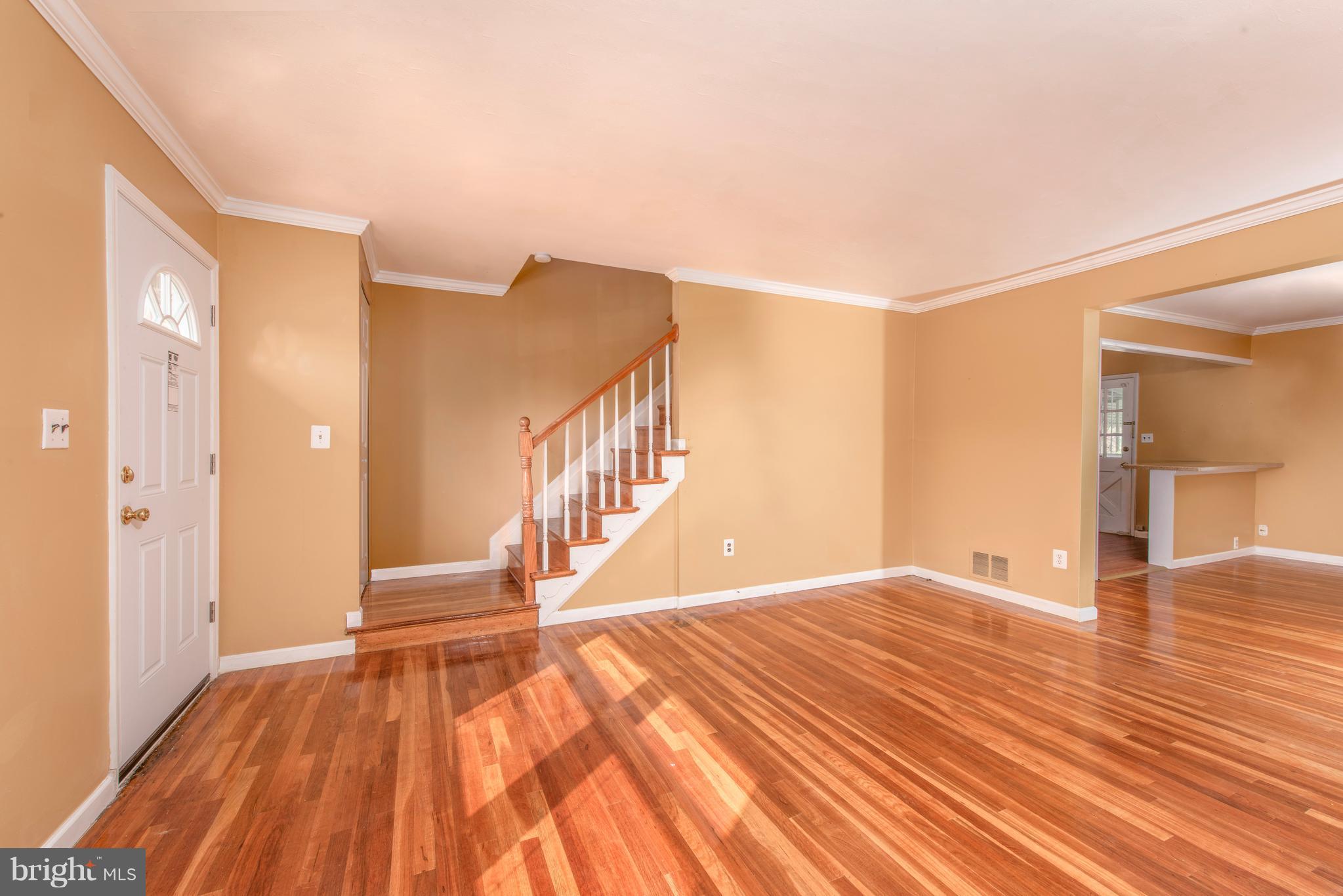 5607 Whitby Road Baltimore, MD 21206 - Photo 3 of 20 a view of an empty room with wooden floor and a window