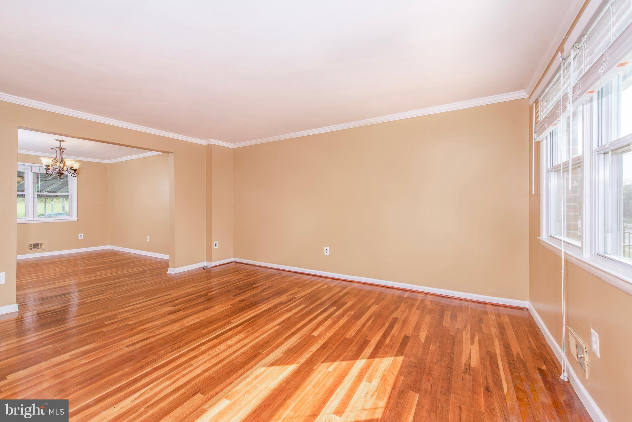 5607 Whitby Road Baltimore, MD 21206 - Photo 4 of 20 a view of empty room with wooden floor and fan