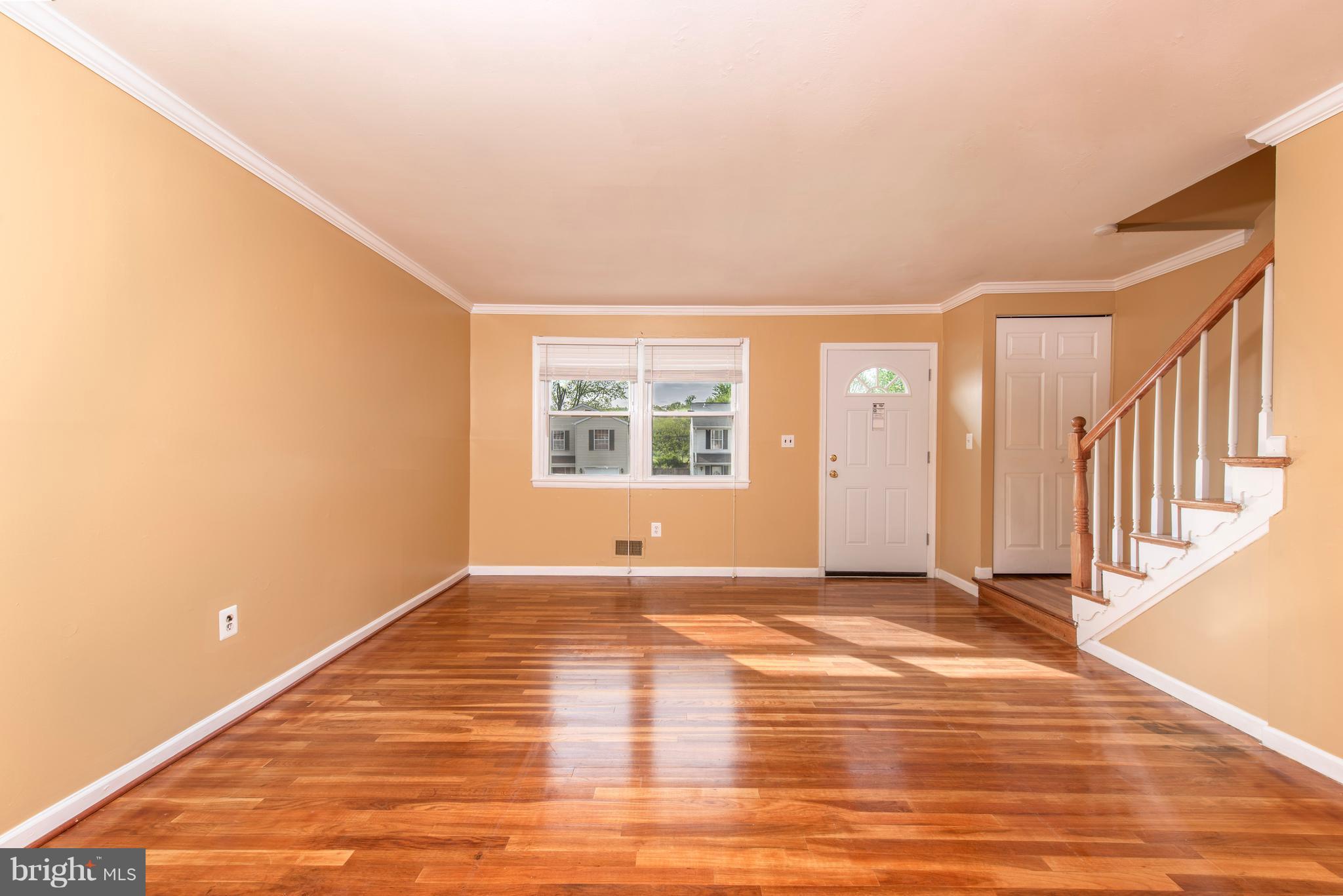 5607 Whitby Road Baltimore, MD 21206 - Photo 5 of 20 a view of an empty room with wooden floor and a window